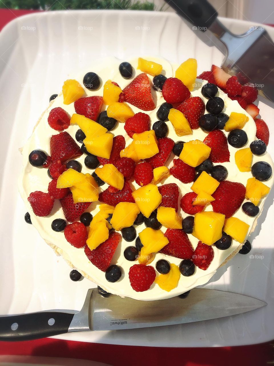 Mango cake with sweet strawberries and berries 