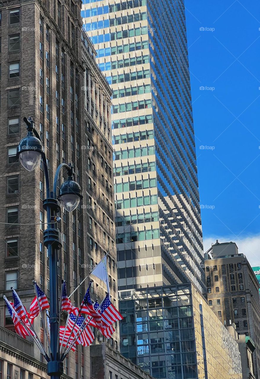 Multiple American Flags on a lamp post. New York.