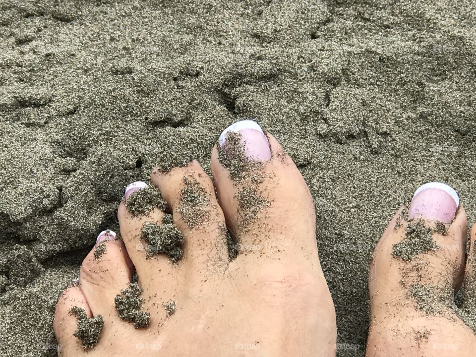 Pink toes in sand