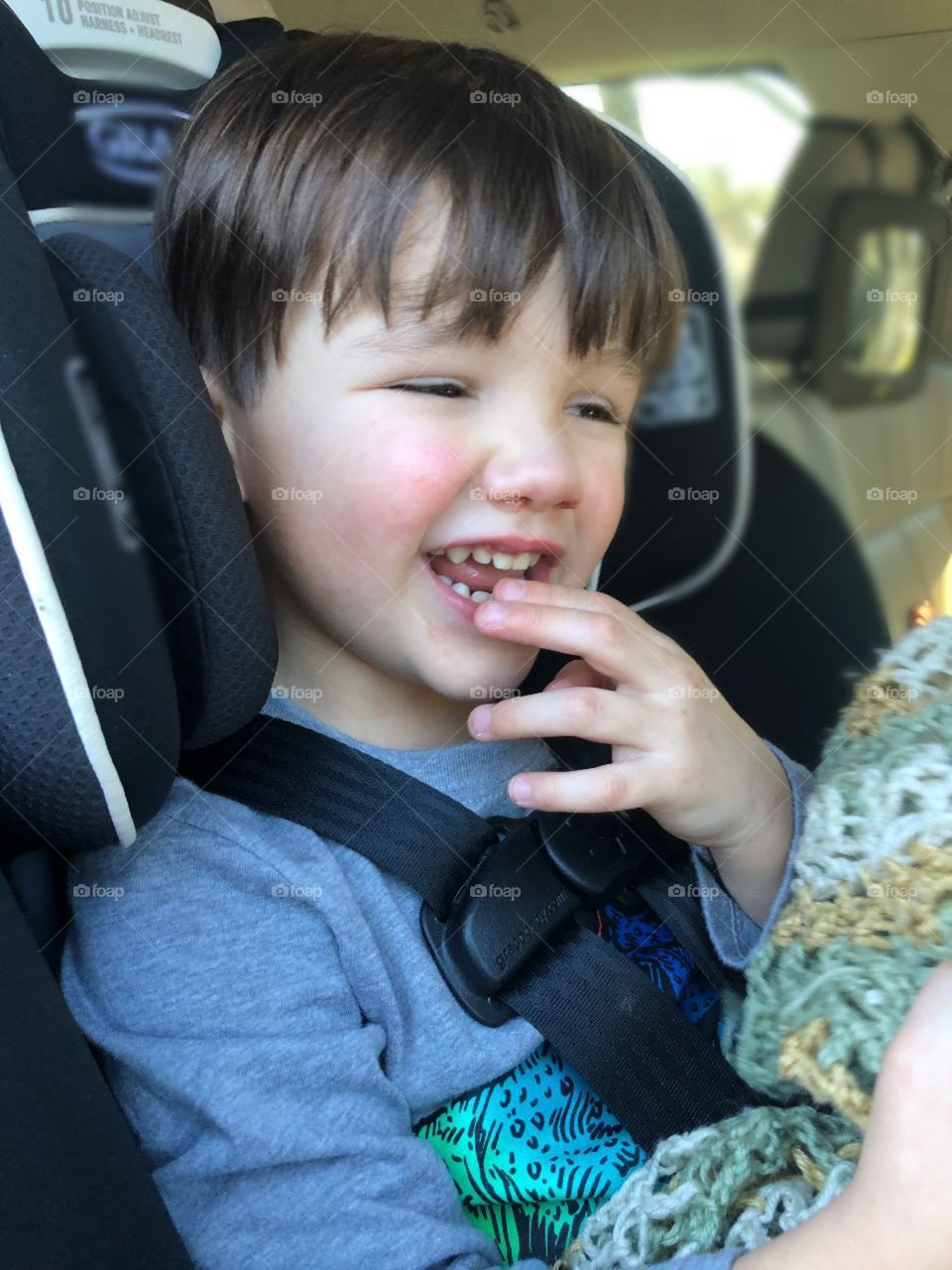 A toddler boy ready for a trip in the car saying goodbye to his grandma. (Me)