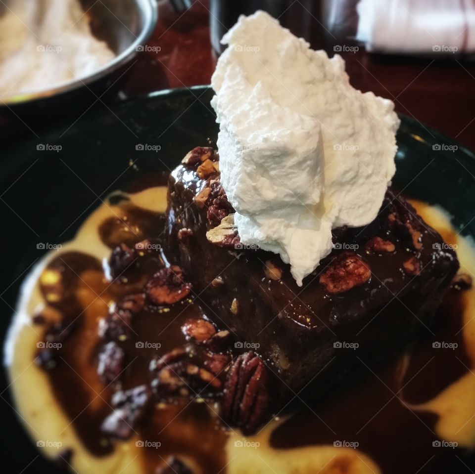 Whiskey Cake with whipped cream and pecans