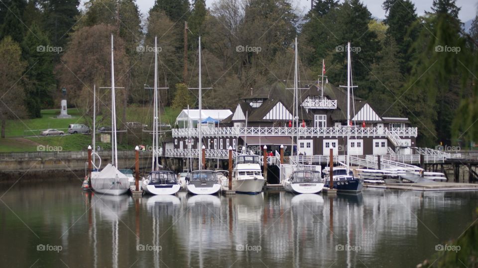 reflections in a line. boats parked outside of Vancouver rowing club in Stanely Park, Vancouver, British Columbia 