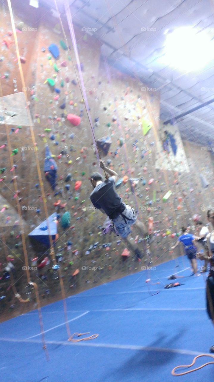 Rock Climbing. My husband came off the wall swinging at The Summit Rock Gym in Dallas