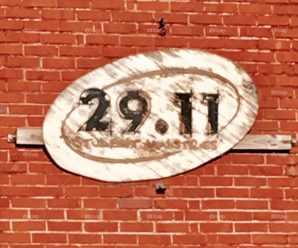 Rustic sign on brick wall