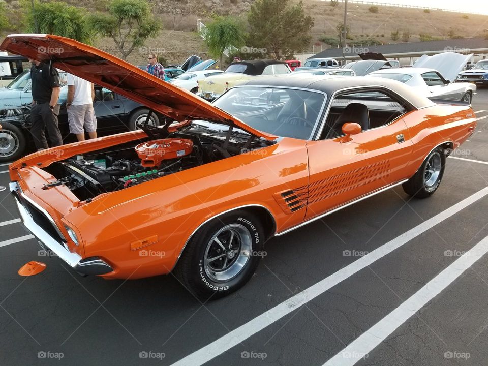 A 1970's Dodge Challenger is a perfect restoration wearing era correct orange with a black vinyl top