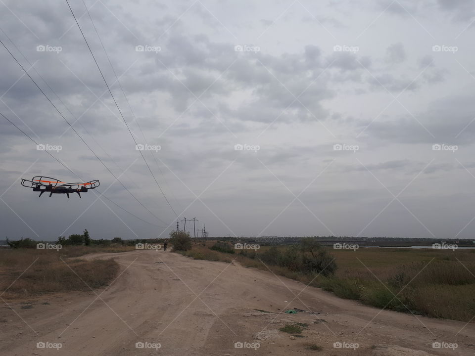 The drone flying under the countryside road