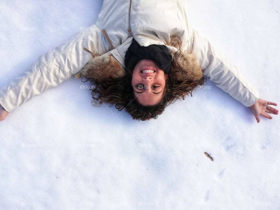 smiling woman stretched in the snow