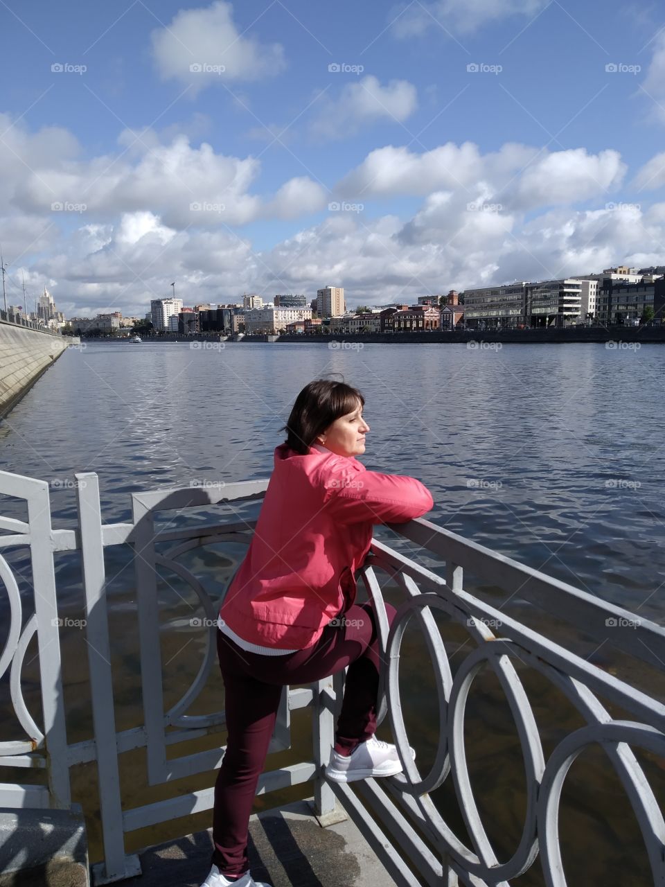 A woman admires the view of the river.