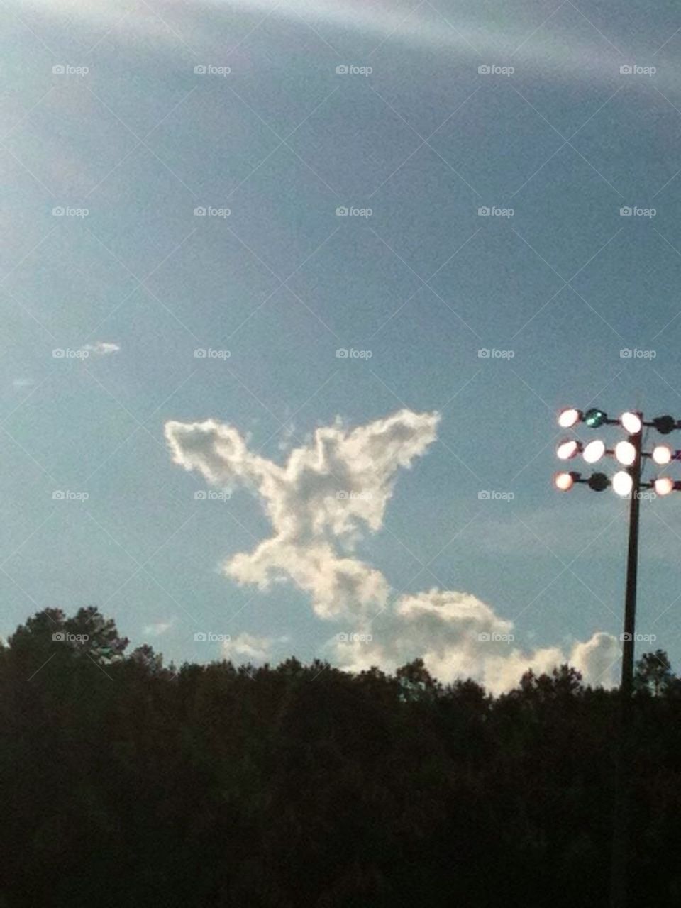 Angel in Clouds. Angel in the sky looking over the Middle School football players.