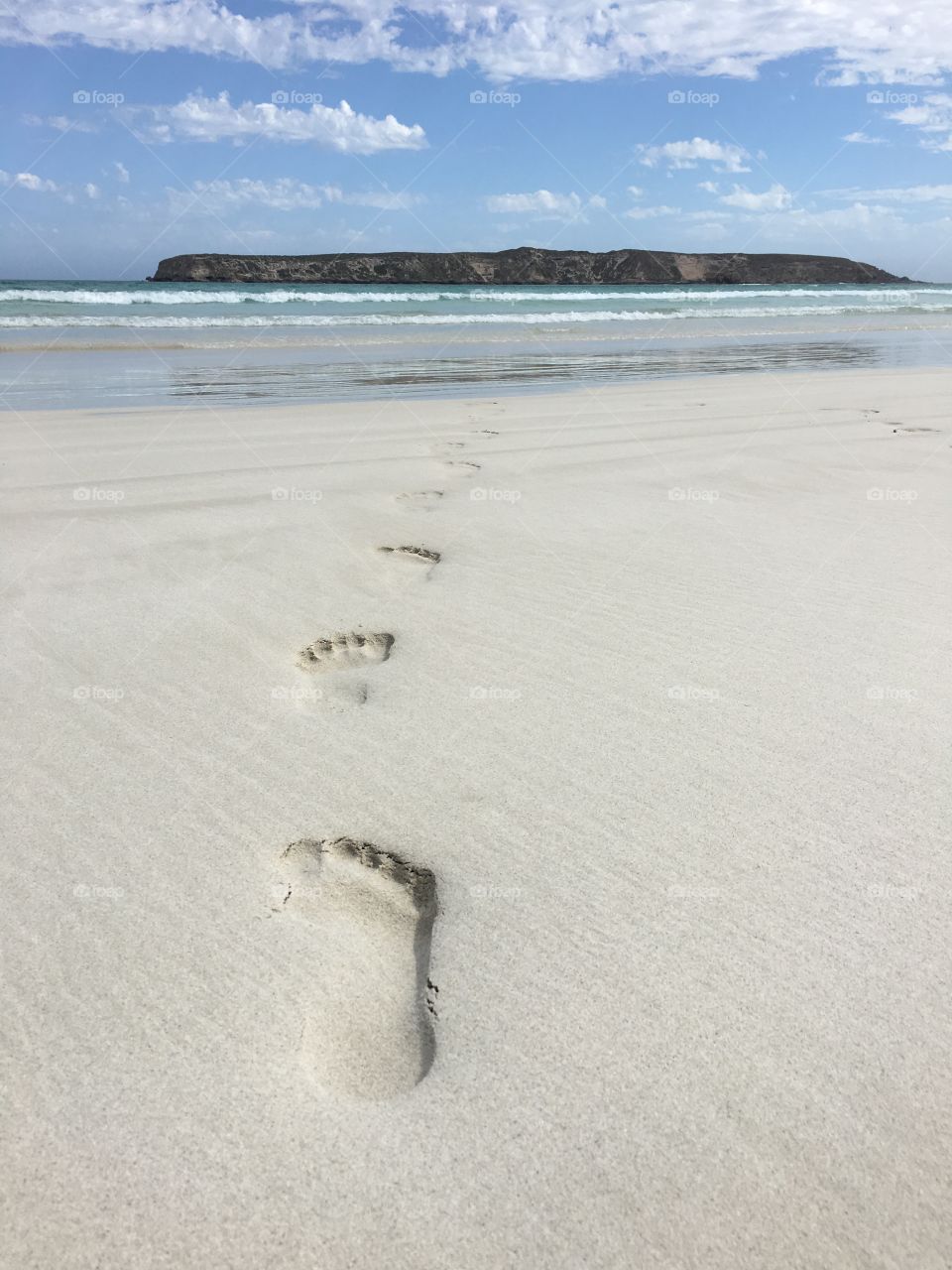 Footprints in sand at beach