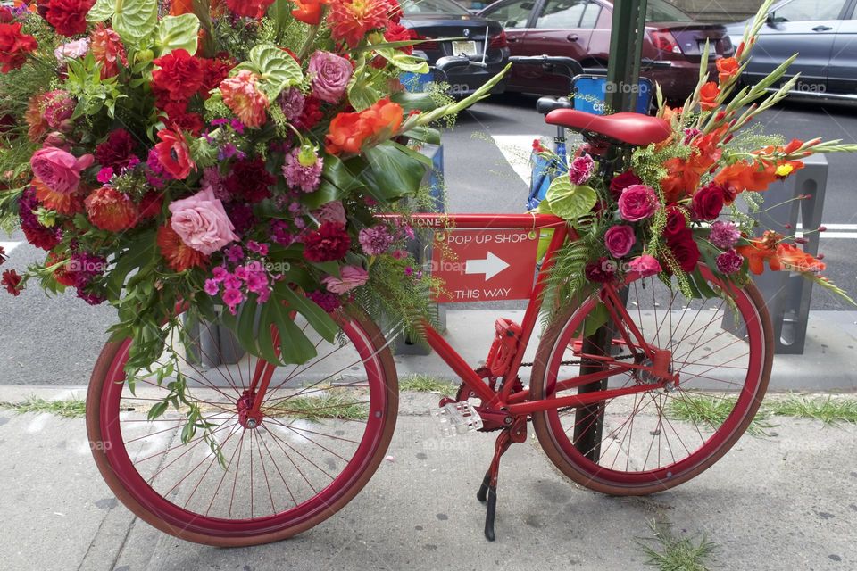 Solitary pink bicycle, decorated with floral bouquet urban setting New York City
