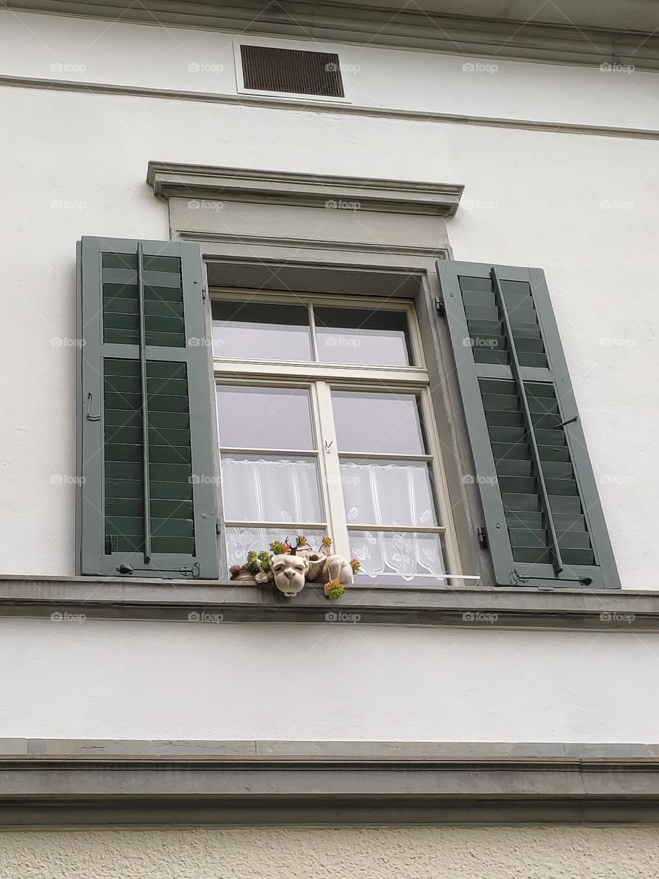 Window with stone animal as decoration