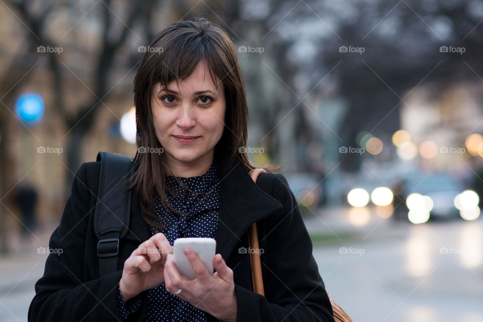 Portrait of woman holding smartphone