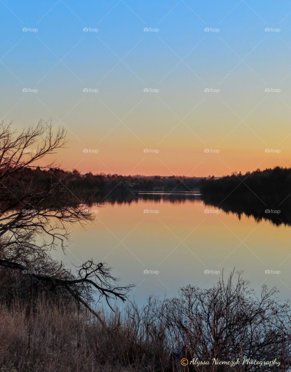Colorful lake scene at sunset. Woodsy frame is my favorite!