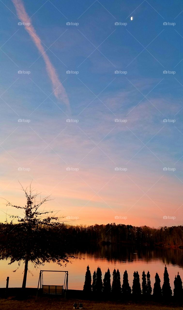 morning moon during pink sunrise.