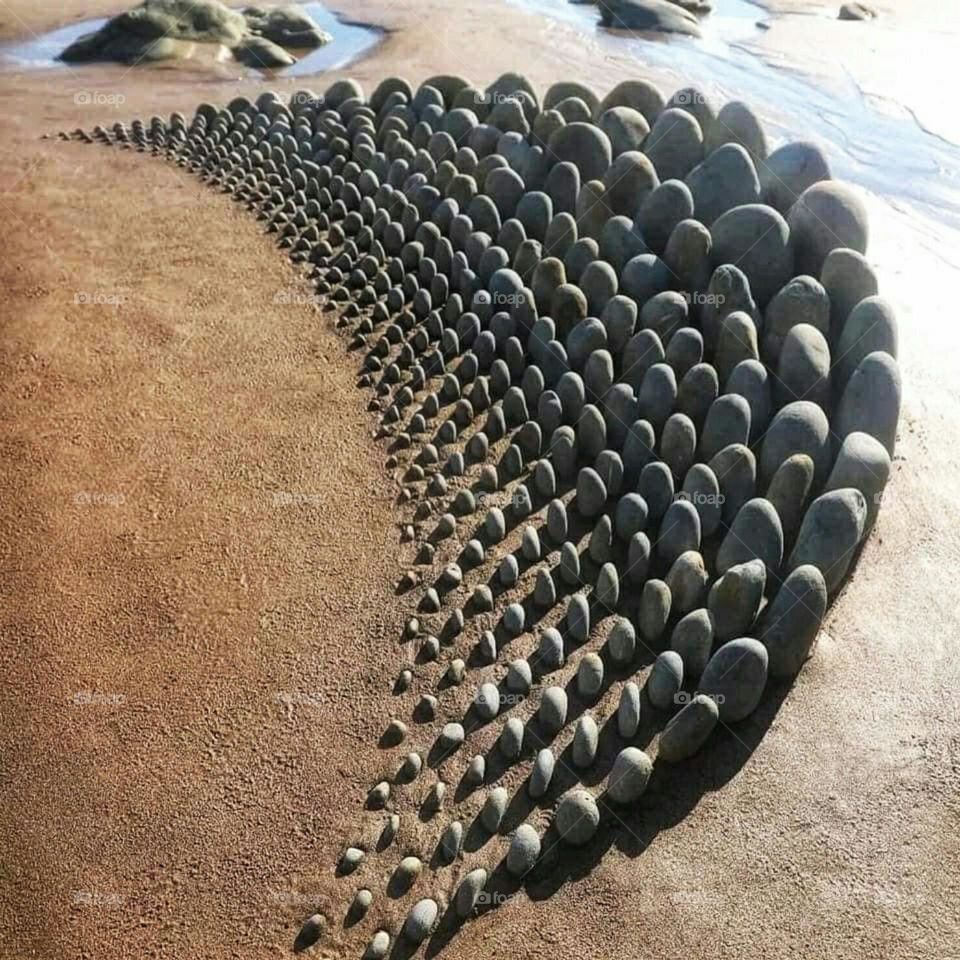 Painting with stones on the beach