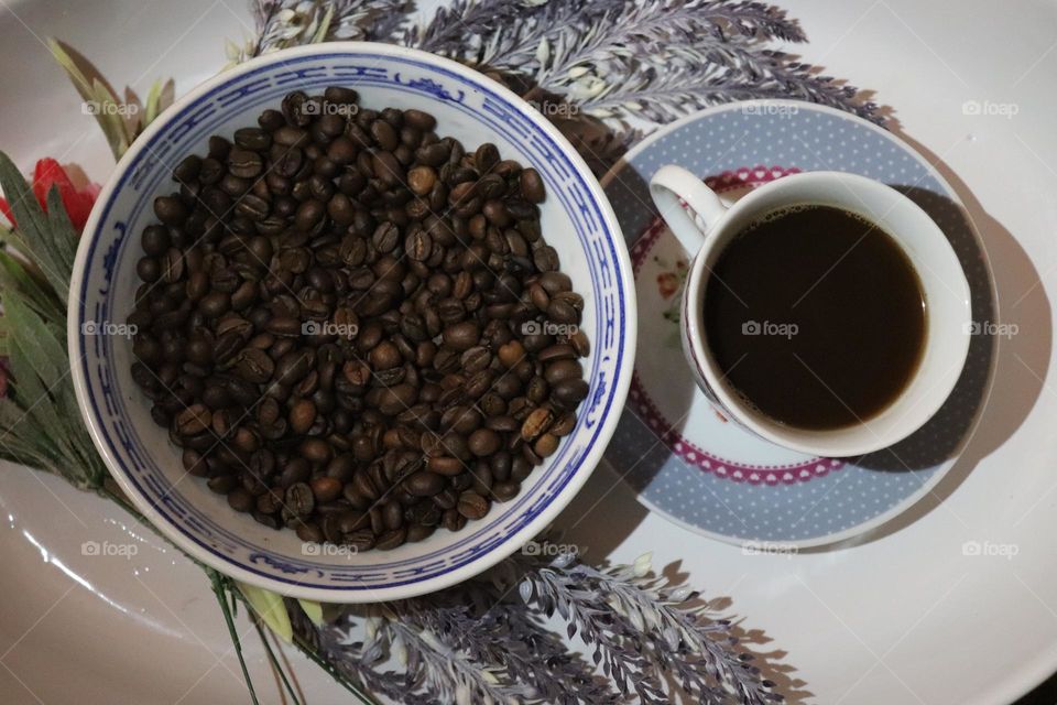 A cup of coffee and coffee beans