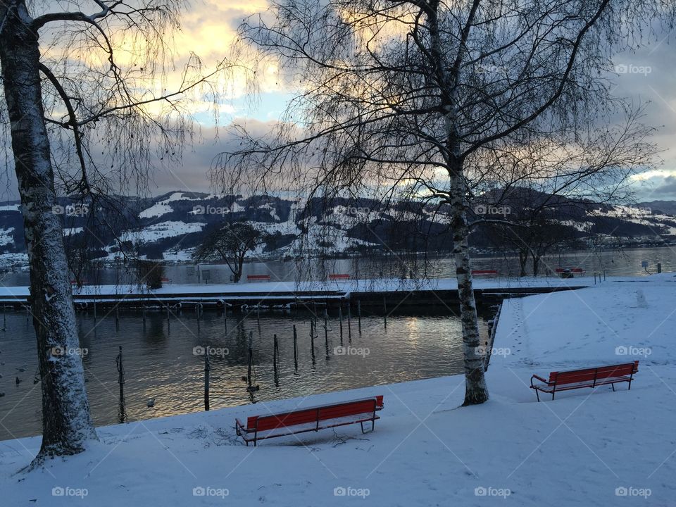 Lake view on a cold winter day - it's getting dark very slowly and in beautiful colors