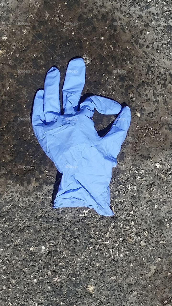 All is OK. A medical glove found in the shape of the OK sign.