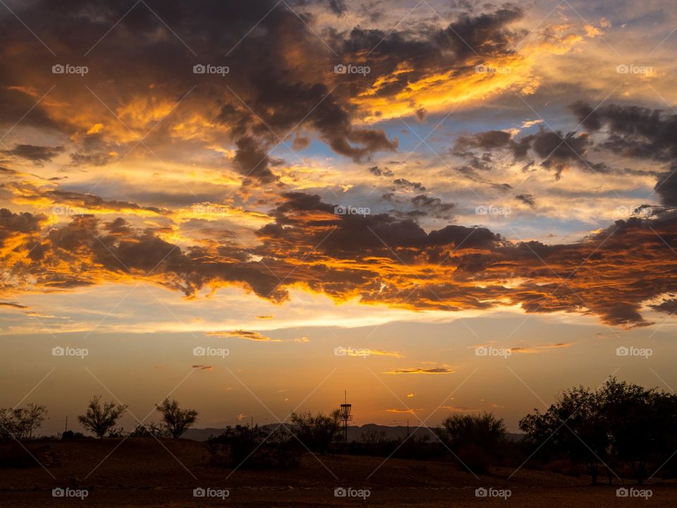 A magnificent desert sunset in Arizona demonstrates the calm before a violent storm rolled in