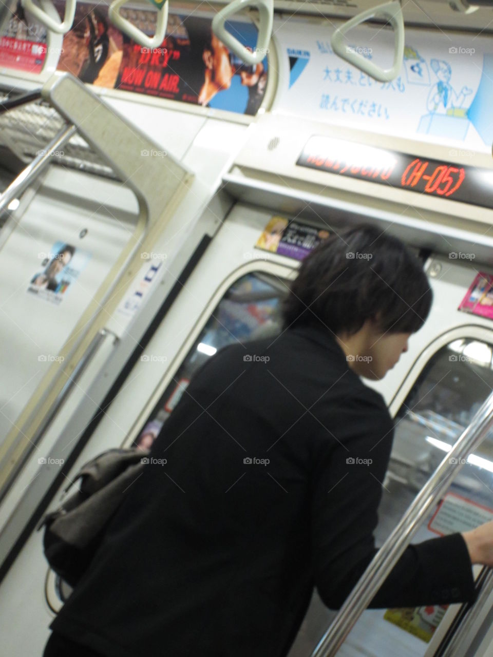 Young man on train, Tokyo, Japan