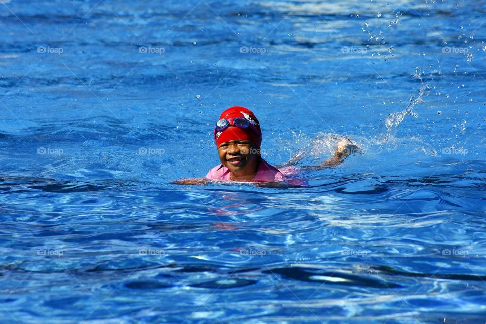 young girl swimming in a pool