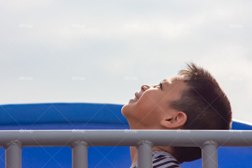 Portrait of Asian boy Look up at the sky Playground