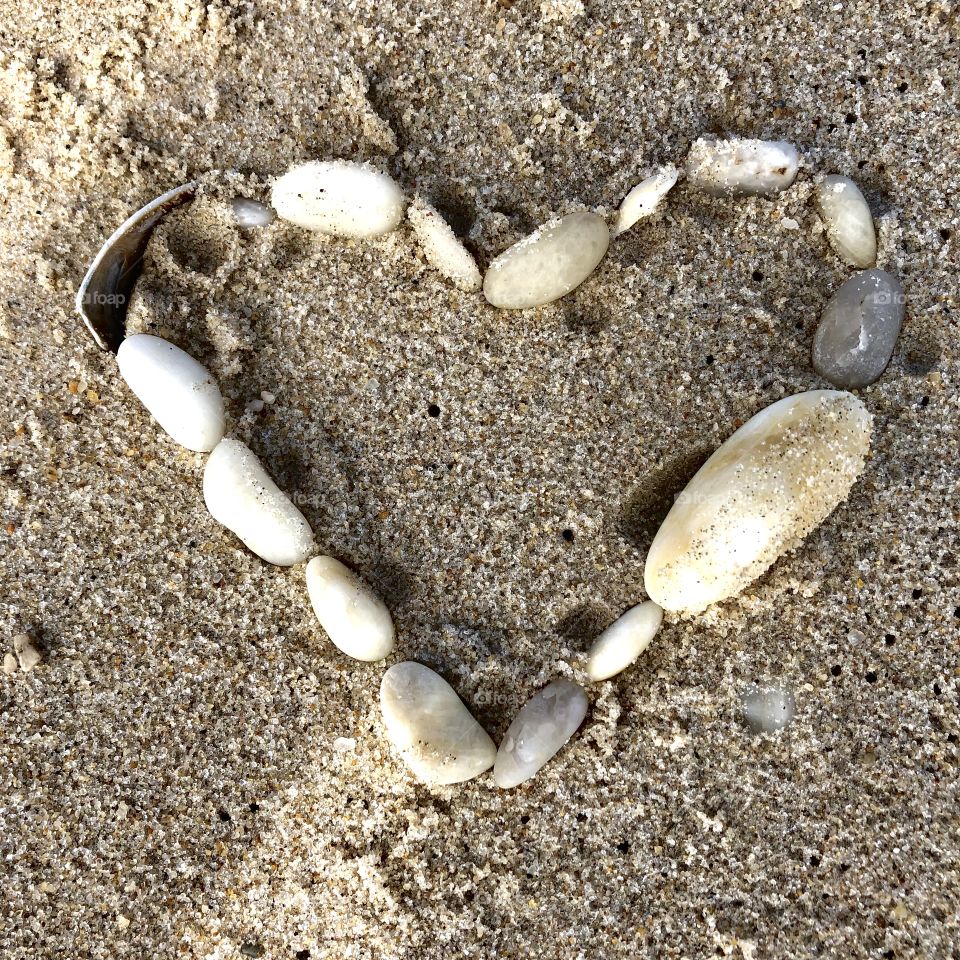 Heart made out of shells on the beach 