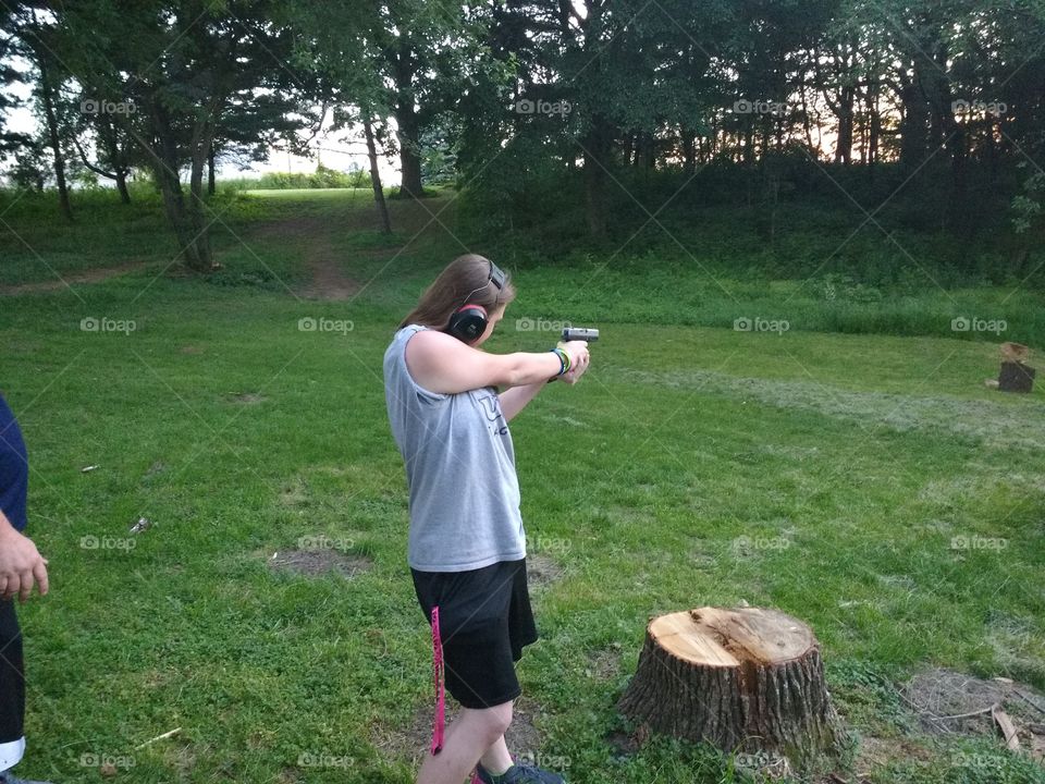 my daughter shooting a 9mm gun at a friend's house.