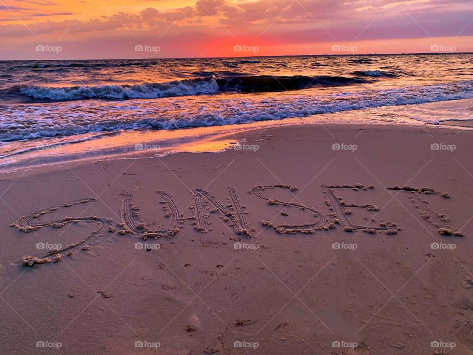 Sunset on the sand - The raspberry-tangerine sherbet skies of an early springtime dusk over — Dusk’s arrival abolishes our fallen world—at least for a day.