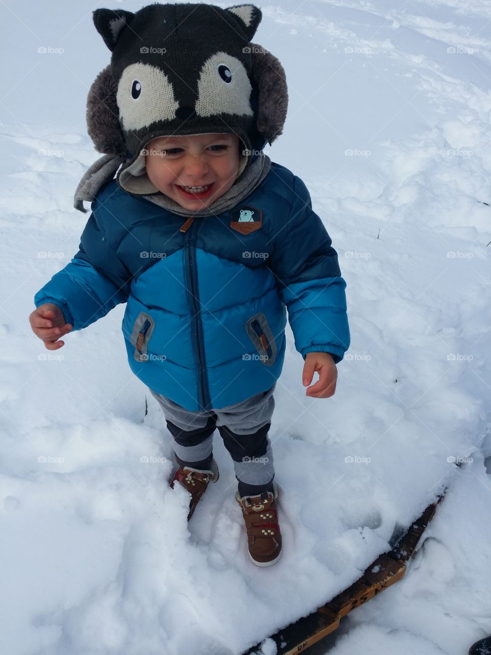High angle view of baby boy standing in snow
