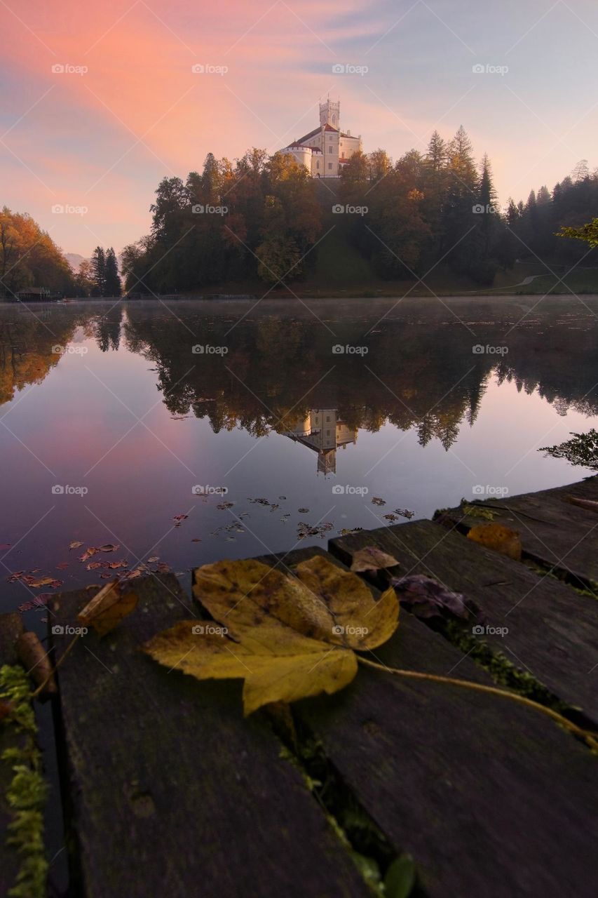 Fall at Trakošćan Castle on the hill reflected in the lake in Croatia, county hrvatsko zagorje