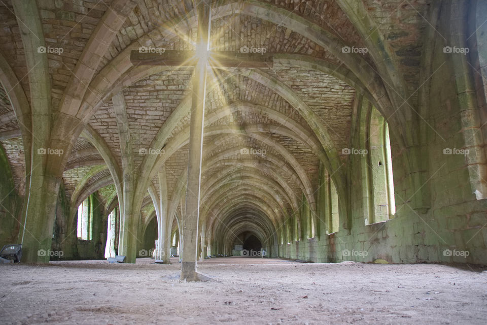 fountains abbey with cross and sun flare