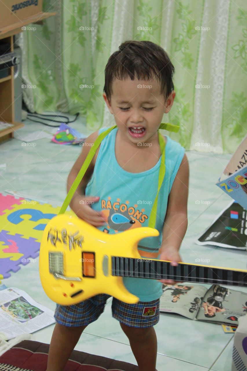 toddler rock star playing guitar