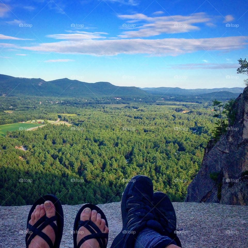 Feet over  cliff  with  mountain  views 