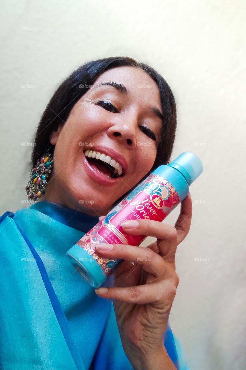 Energetic, Light - Hearted Portrait of Beautiful Woman  with Products