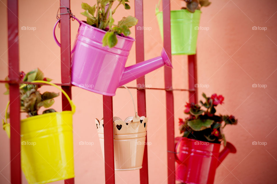 colorful flower pots. colorful flower pots hanging in the garden