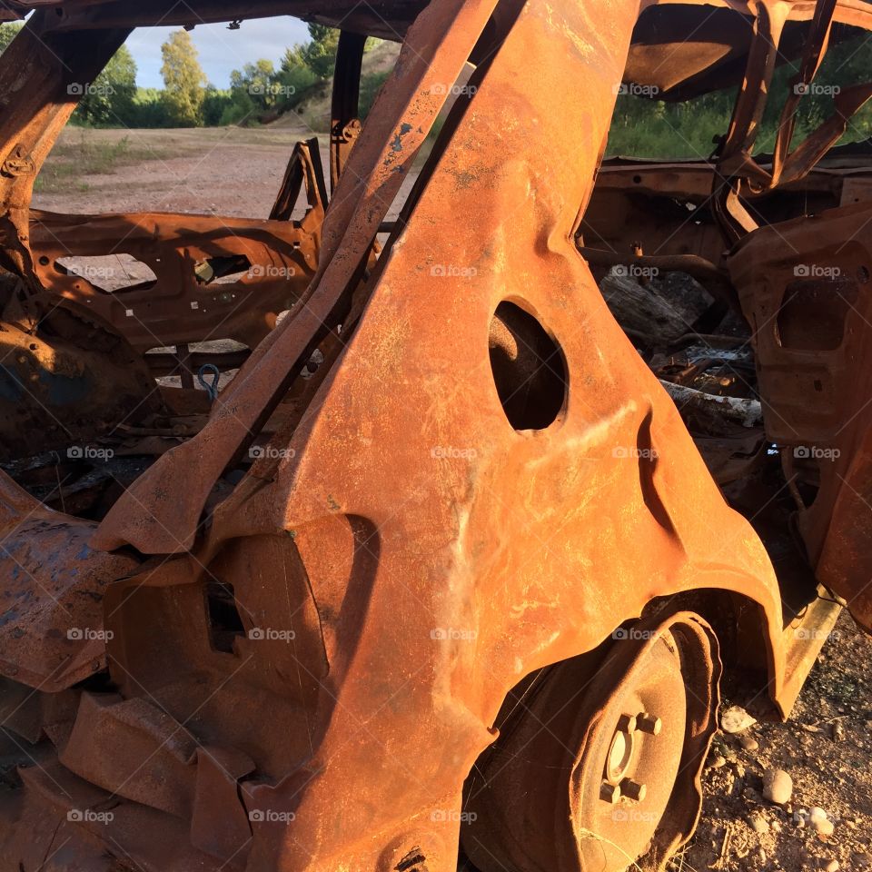 Rusty burnt out car abandoned