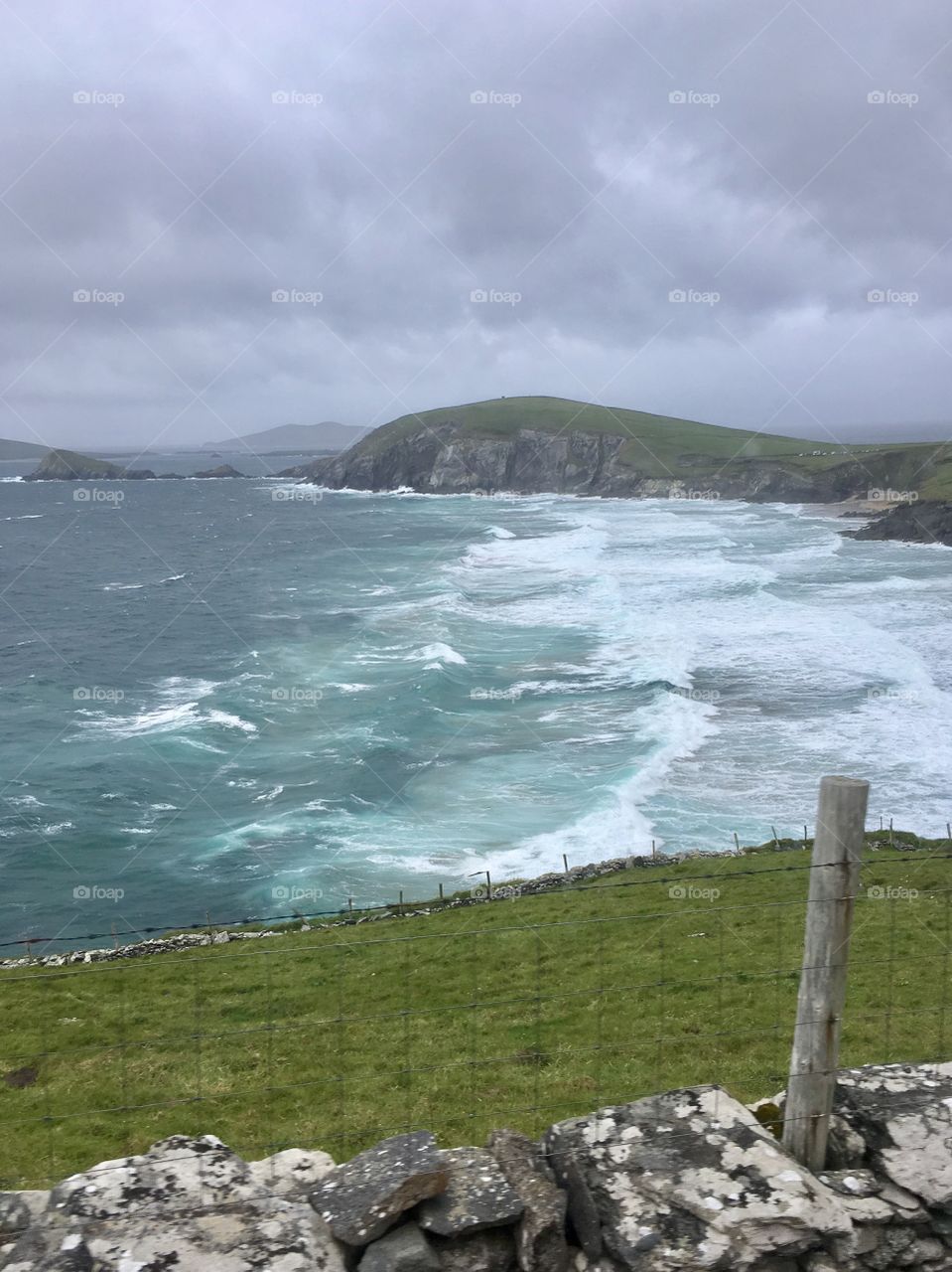 Waves, mountains, and fence