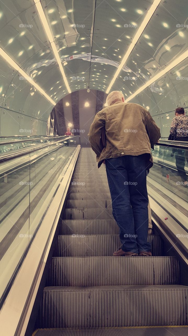 Old man in metro station, big city life.