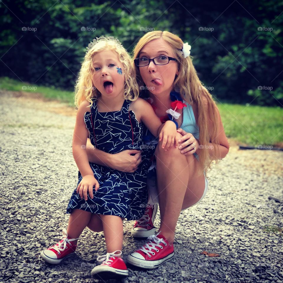 A mother and daughter acting silly on the 4th of July