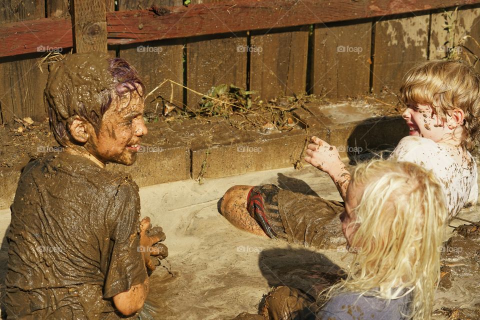 Kids Playing In Mud In Summer