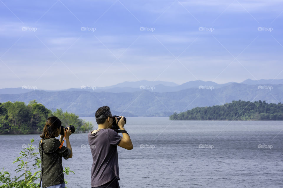 Tourists take pictures with the Kaeng Krachan Dam ,Phetchaburi in Thailand. December 16, 2018.