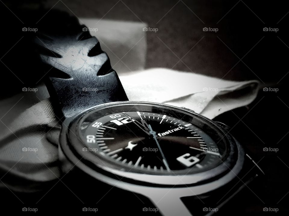 FastTrack black analogue watch showing  time in hours minutes and seconds. Time in picture is 12.45.