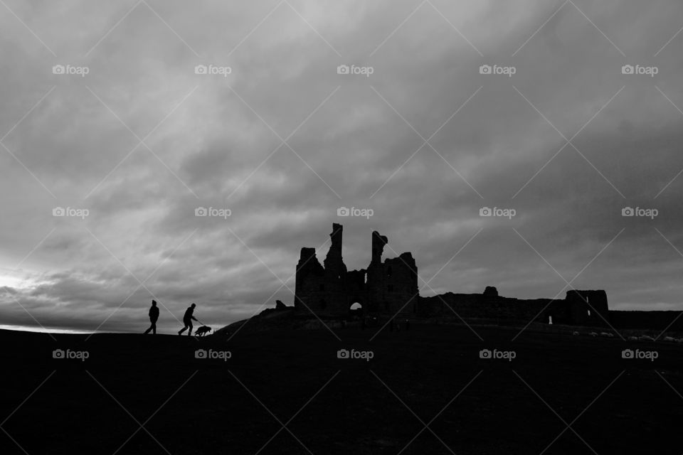 Dark sky with black silhouette of my family and dog 