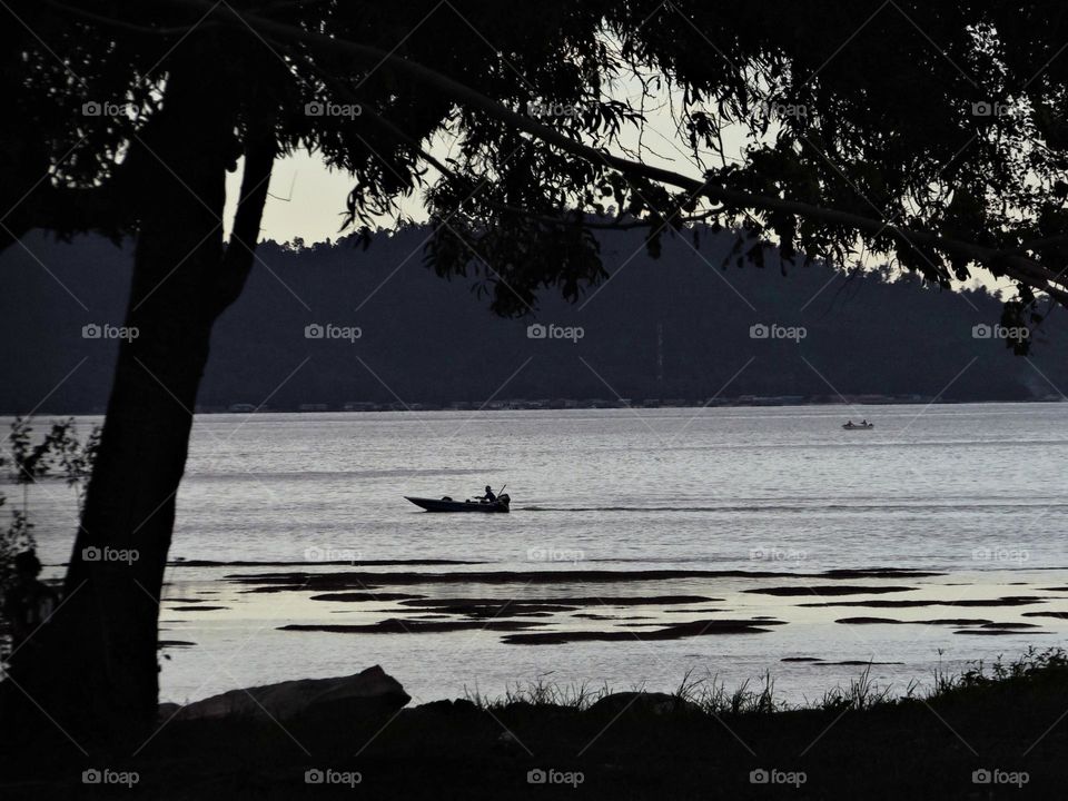 a fisherman who was passing by made a beautiful twilight scene
