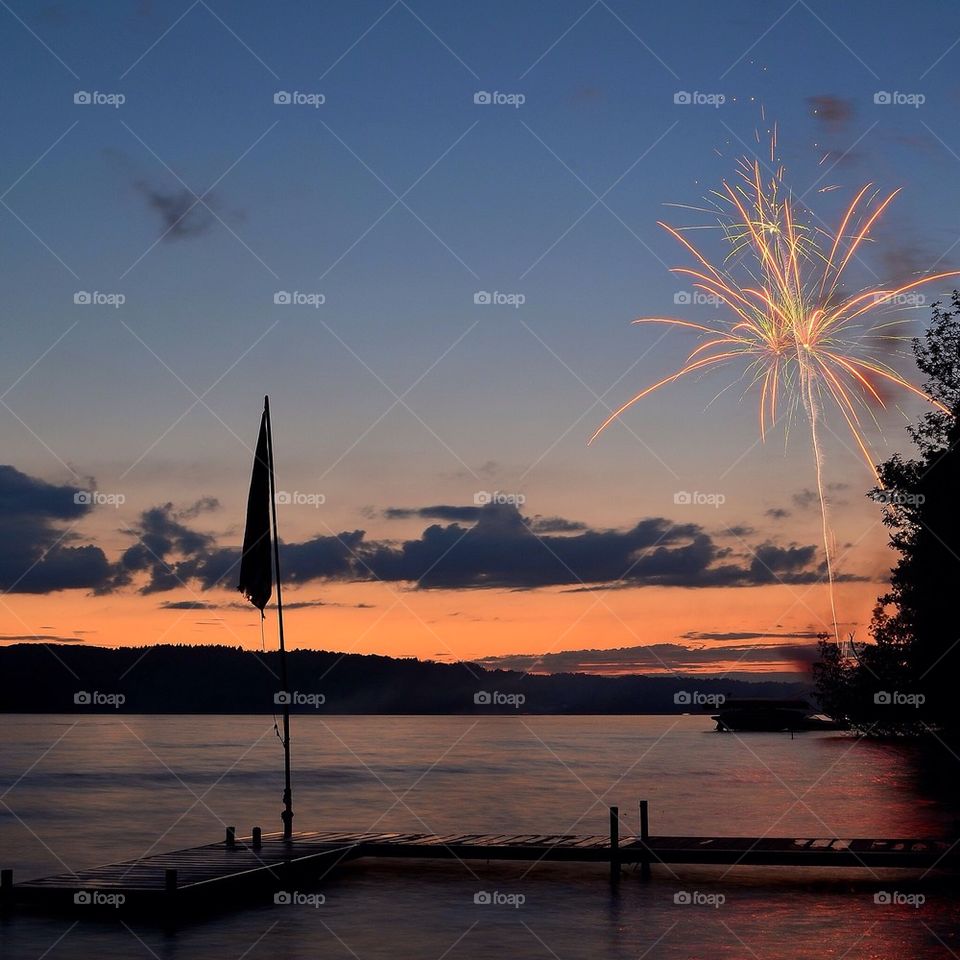 Firework display during sunset