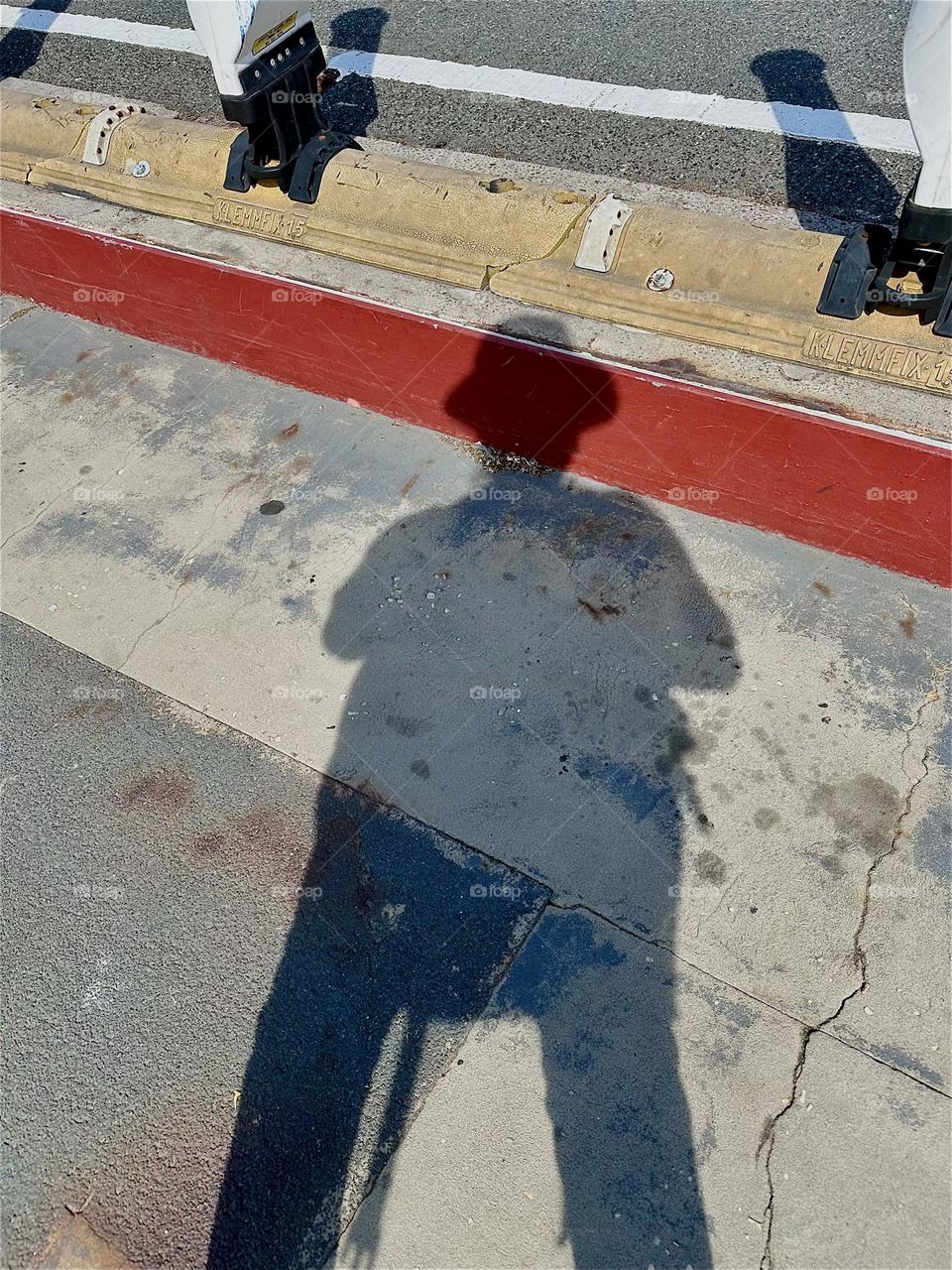 This dramatic looking shadow was cast onto the pedestrian lane of the „Pulaski Bridge“ at „Newtown Creek“ that connects „Greenpoint“, Brooklyn to LIC, Queens at a certain time in the afternoon when the sun begins to set. 2024. Hypnotic Productions