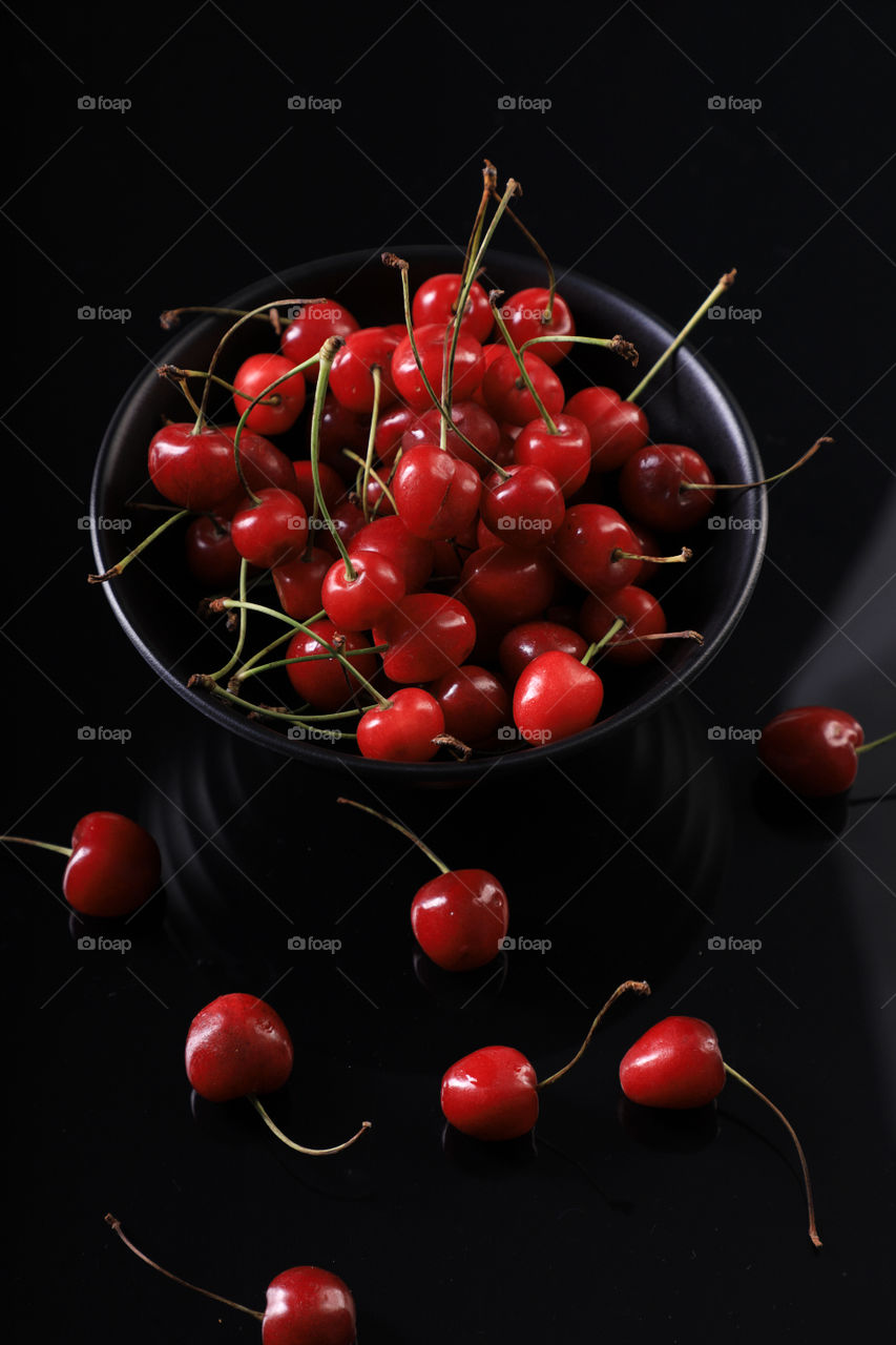 Cherries in a black bowl