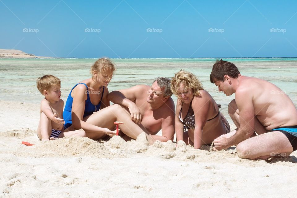 Big family. large family playing in the sand on the beach